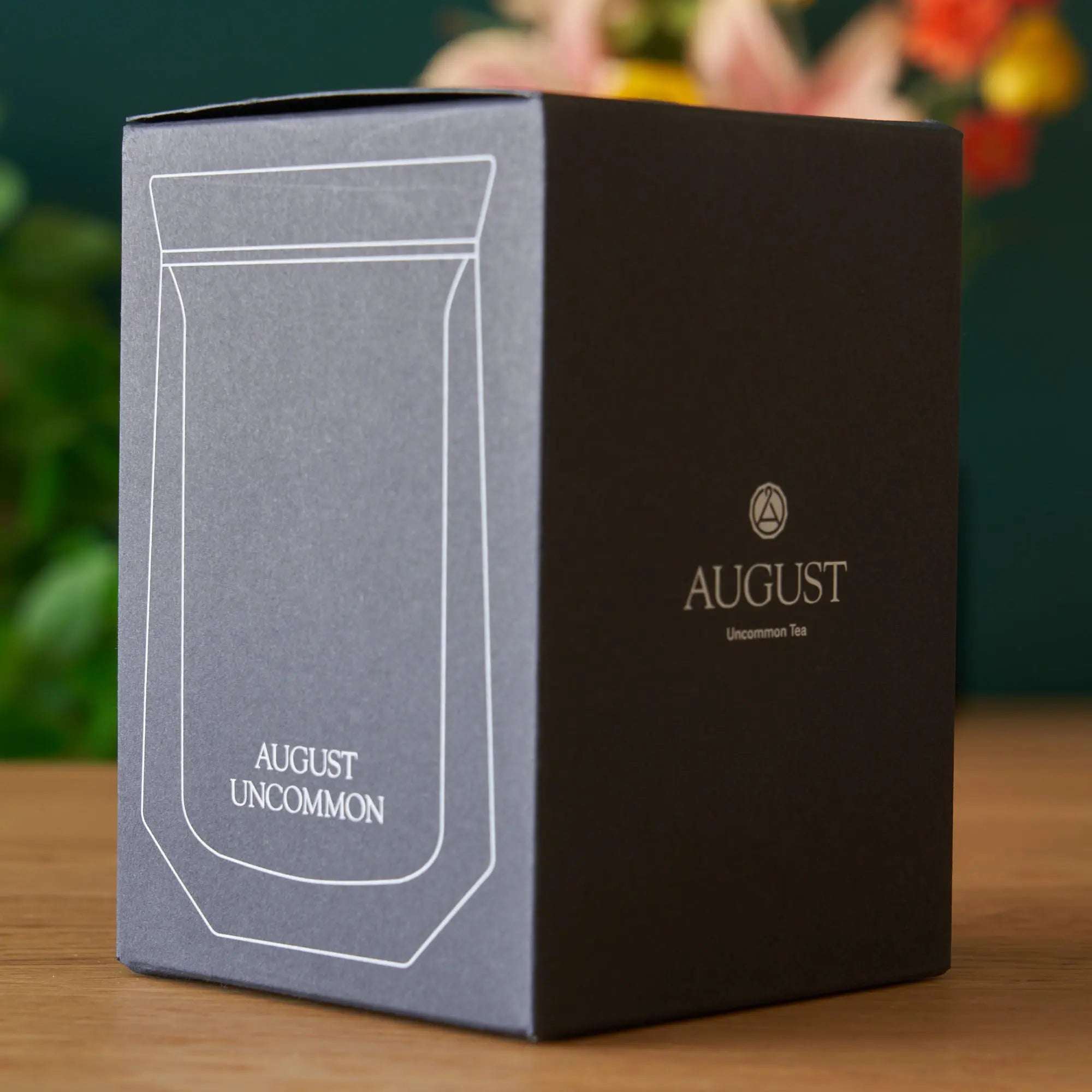 Tasting Glass packaging box in black and grey with a white outline illustration and August Uncommon branding