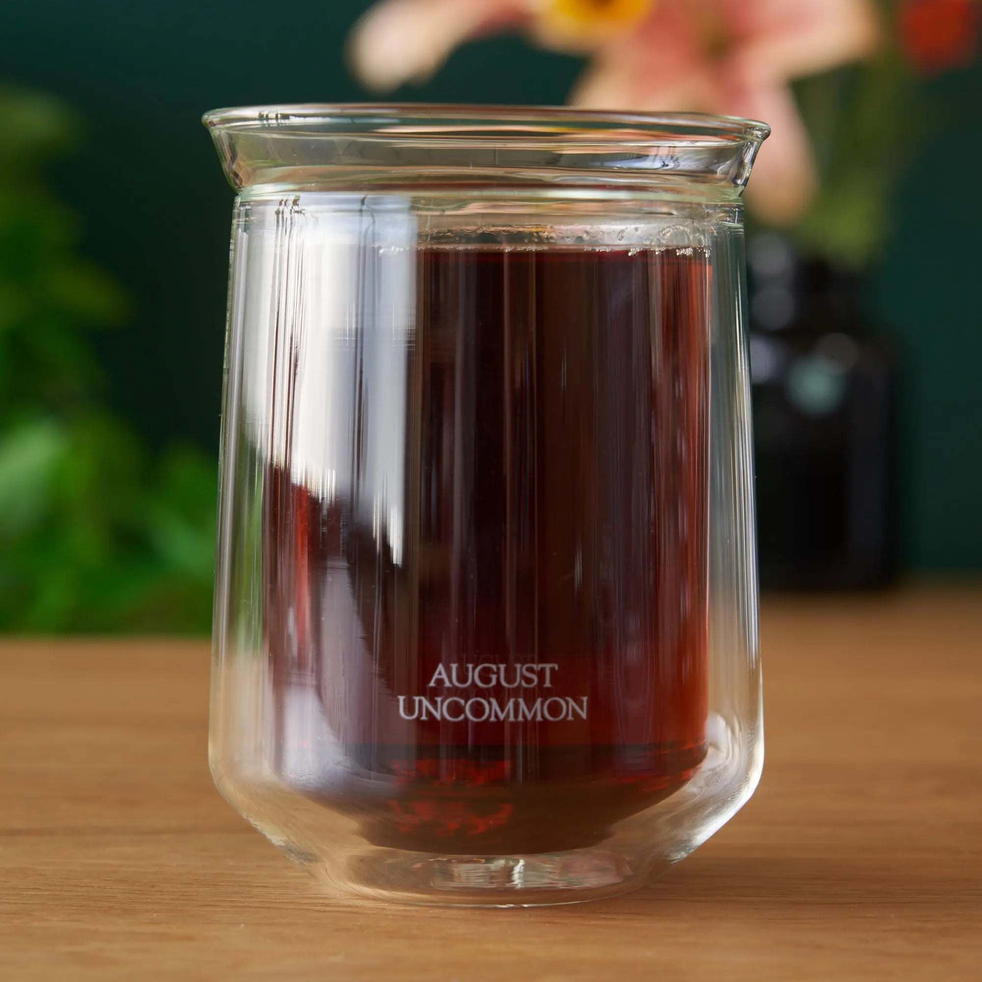 Tasting Glass in clear double-walled glass, filled with dark tea and featuring a flared rim