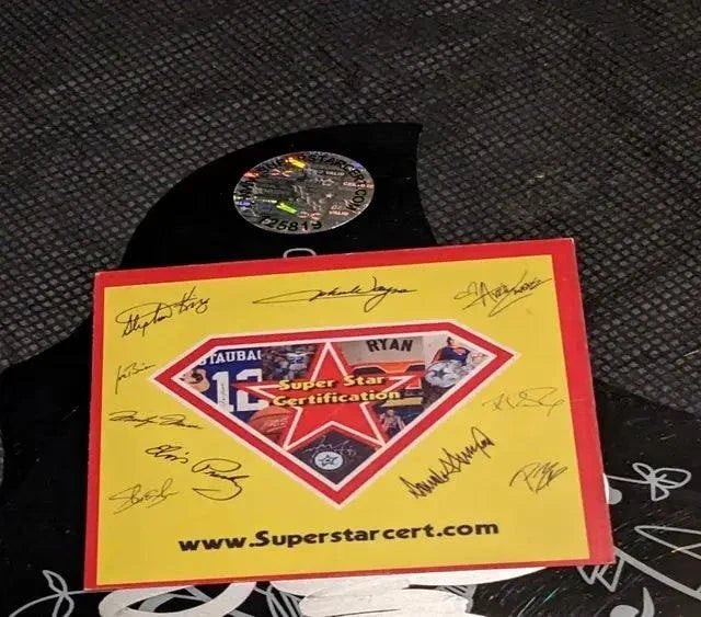 Taylor Swift Signed Pickguard in glossy black with multiple visible signatures and accompanying Superstar certification card