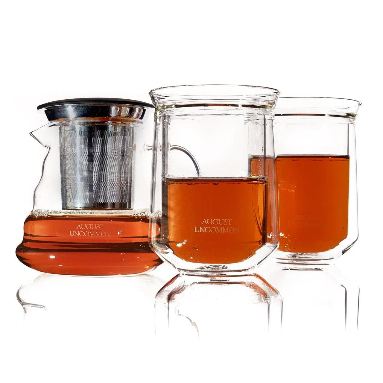 Tea For Two - Starter Tea Set with clear glass teapot, two tasting glasses, stainless steel infuser, and amber tea
