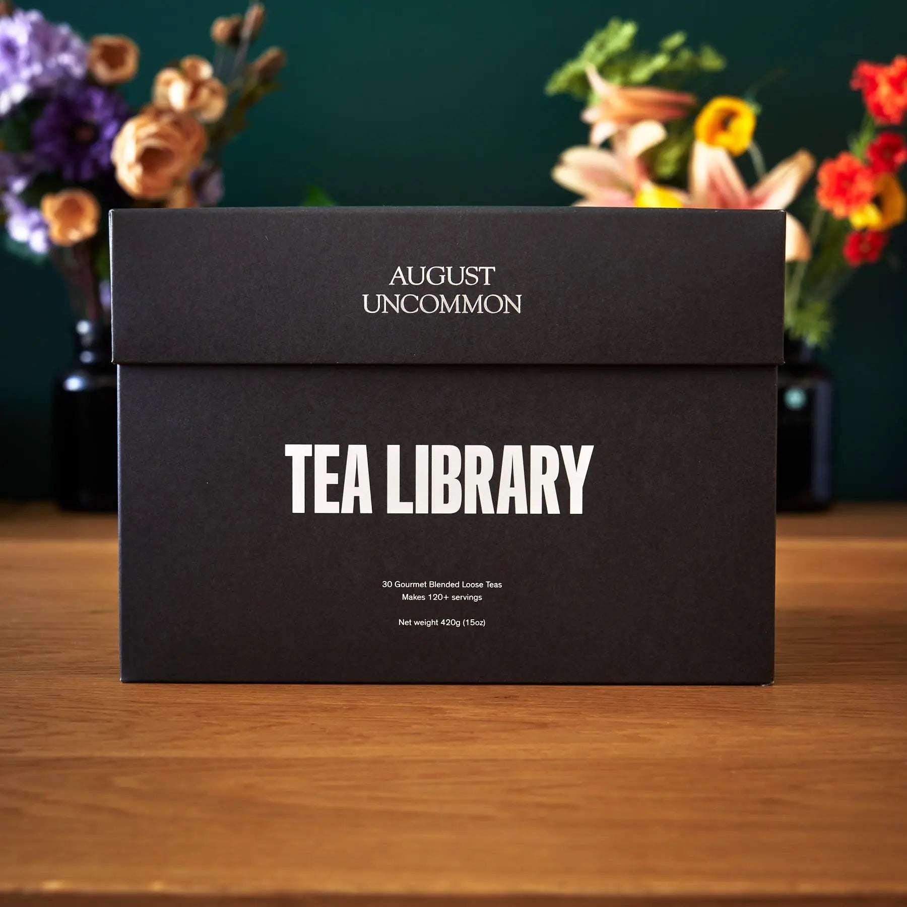 Tea Library - Deluxe black rectangular tea sampler box with bold white lettering and August Uncommon branding