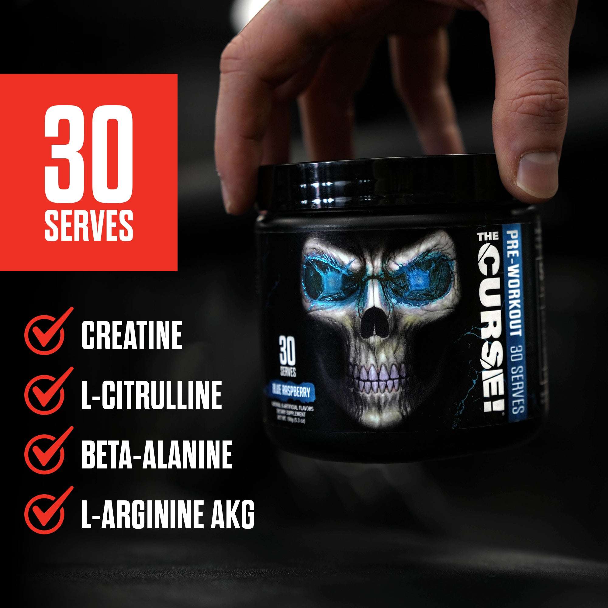 The Curse pre-workout 30 Serve black container with skull artwork and blue raspberry flavor label held by hand with red text and ingredient check marks nearby