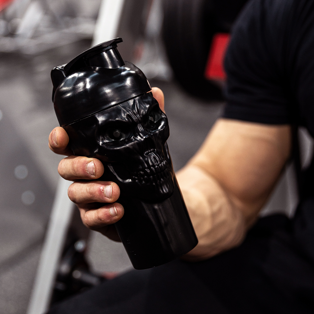 The Curse! Skull Shaker gym bottle in black with a detailed skull design, screw-on lid, and mixing ball for leak-free use