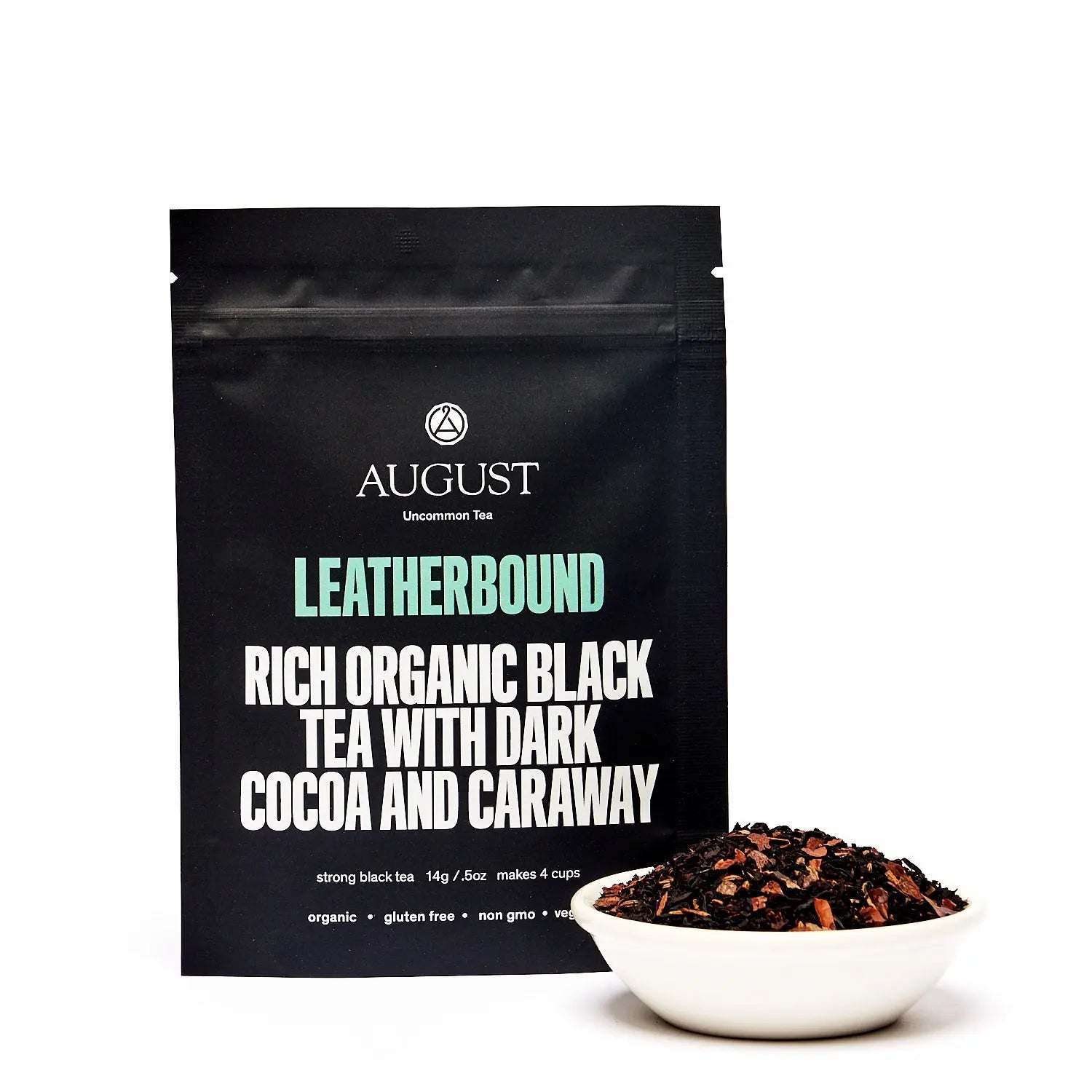 Black tea pouch with rich organic blend, dark cocoa and caraway, paired with loose black tea in a white bowl