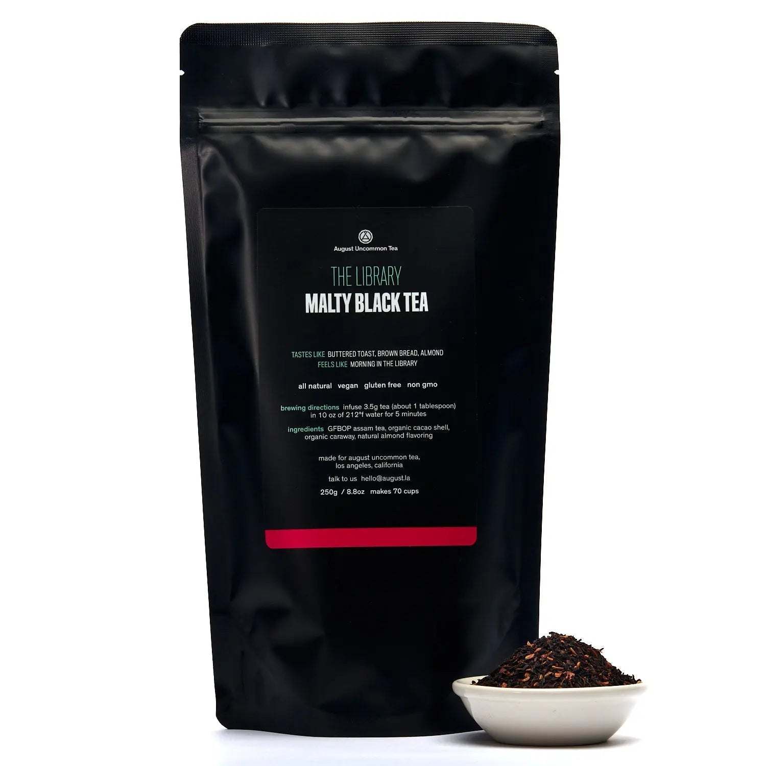 The Library - Black Tea in a matte black resealable pouch with loose dark tea leaves in a white bowl