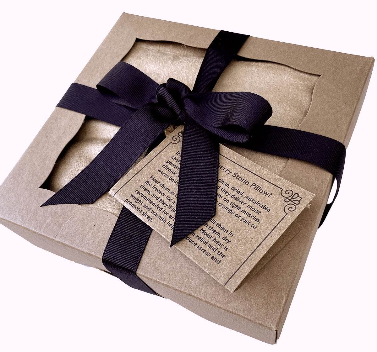 Triple Square Cherry Stone Pillow packaged in a tan cardboard gift box with a black ribbon and bow