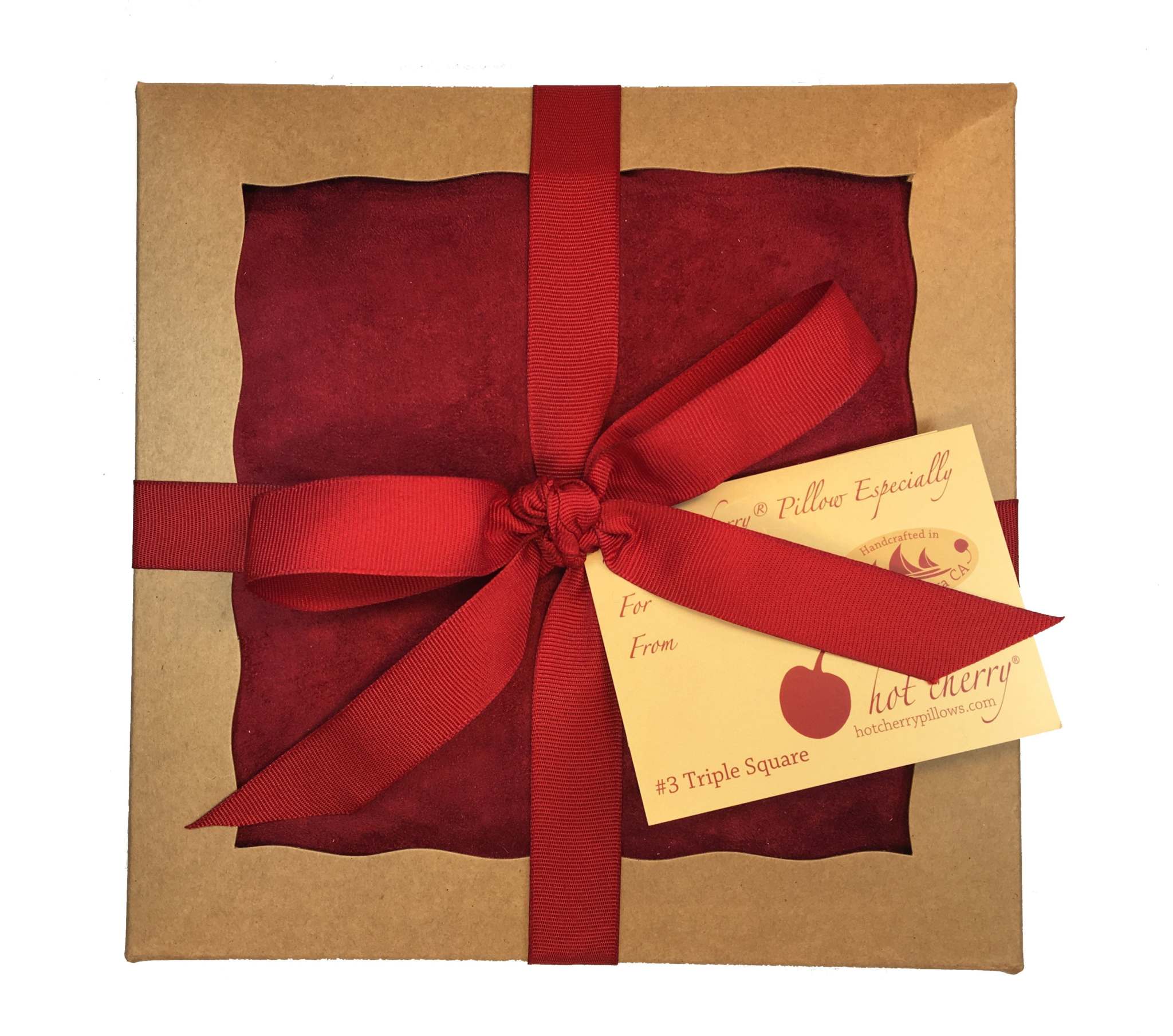 Triple Square pillow in deep red plush fabric, packaged in a kraft gift box with a matching ribbon and gift tag