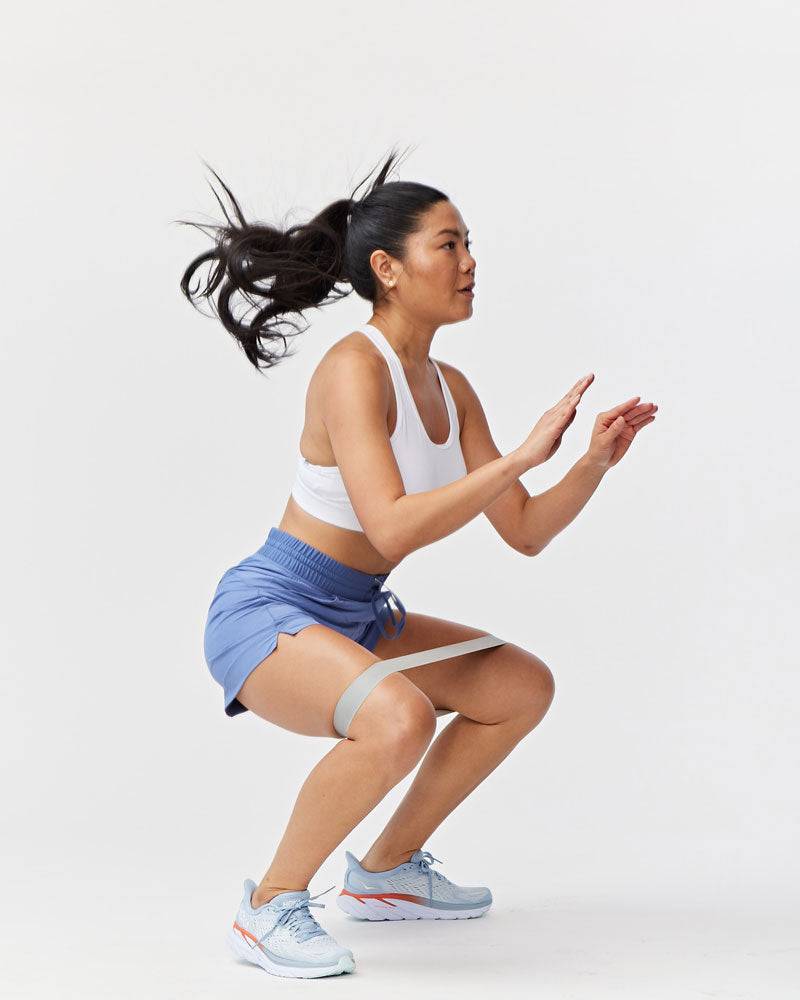 Triple V Womens Athletic Shorts in blue lightweight fabric with a drawstring waist, shown with a white crop top