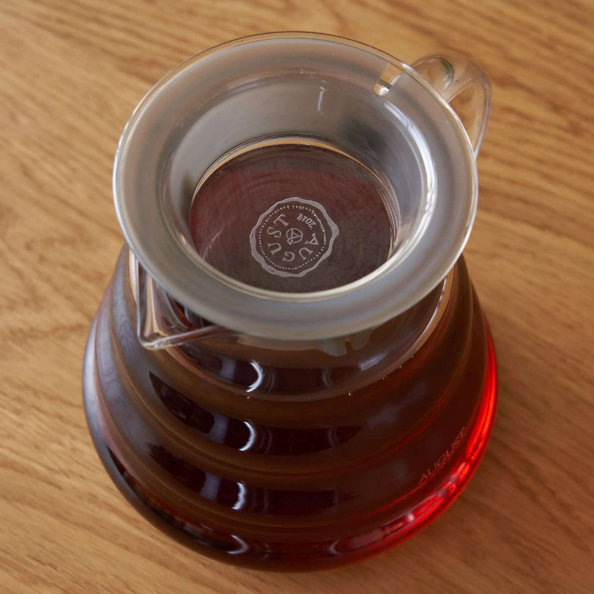 Two Cup Glass Teapot in clear heatproof glass with amber tea and built-in infuser