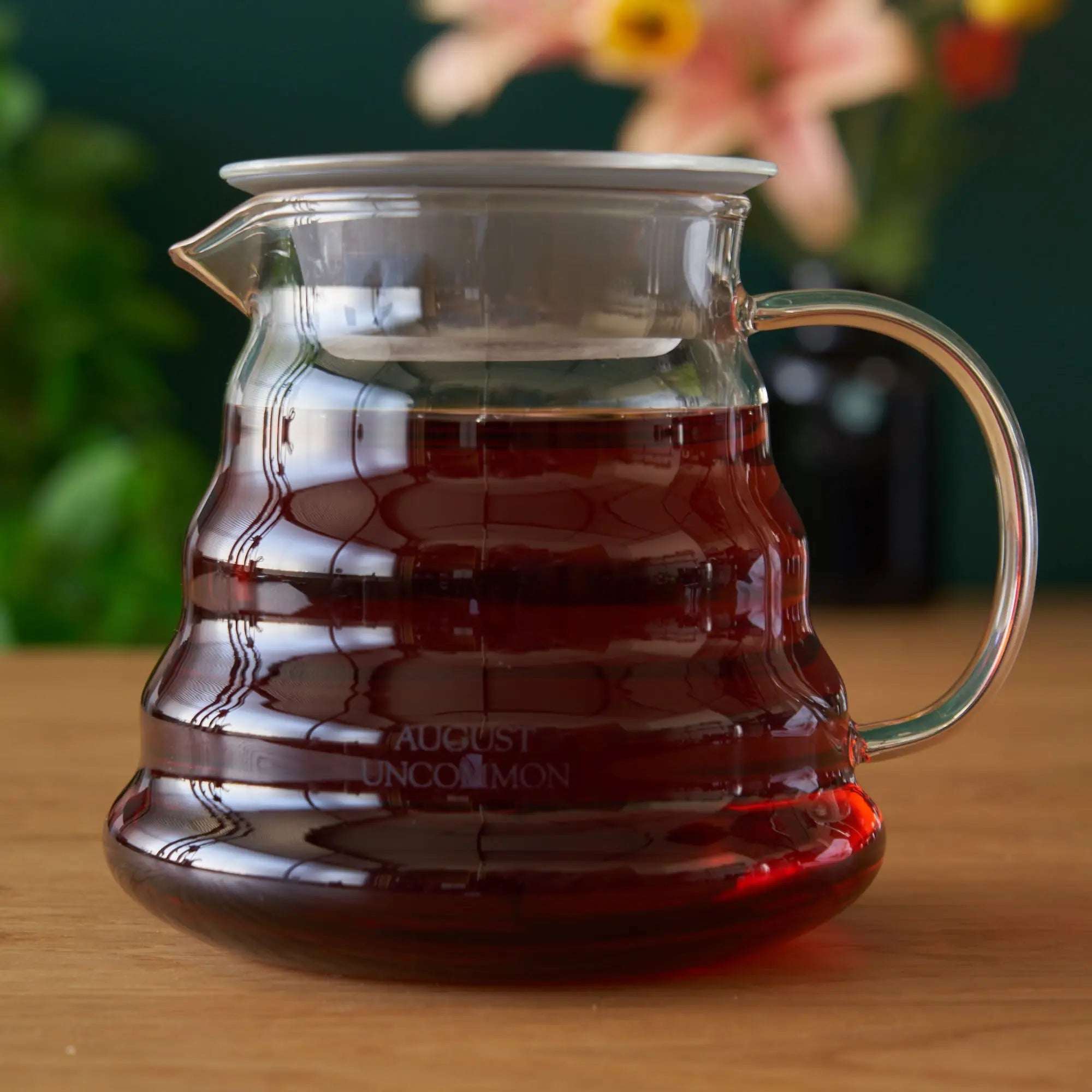 Two Cup Glass Teapot in clear heatproof glass with curved handle, spout, lid and dark brewed tea