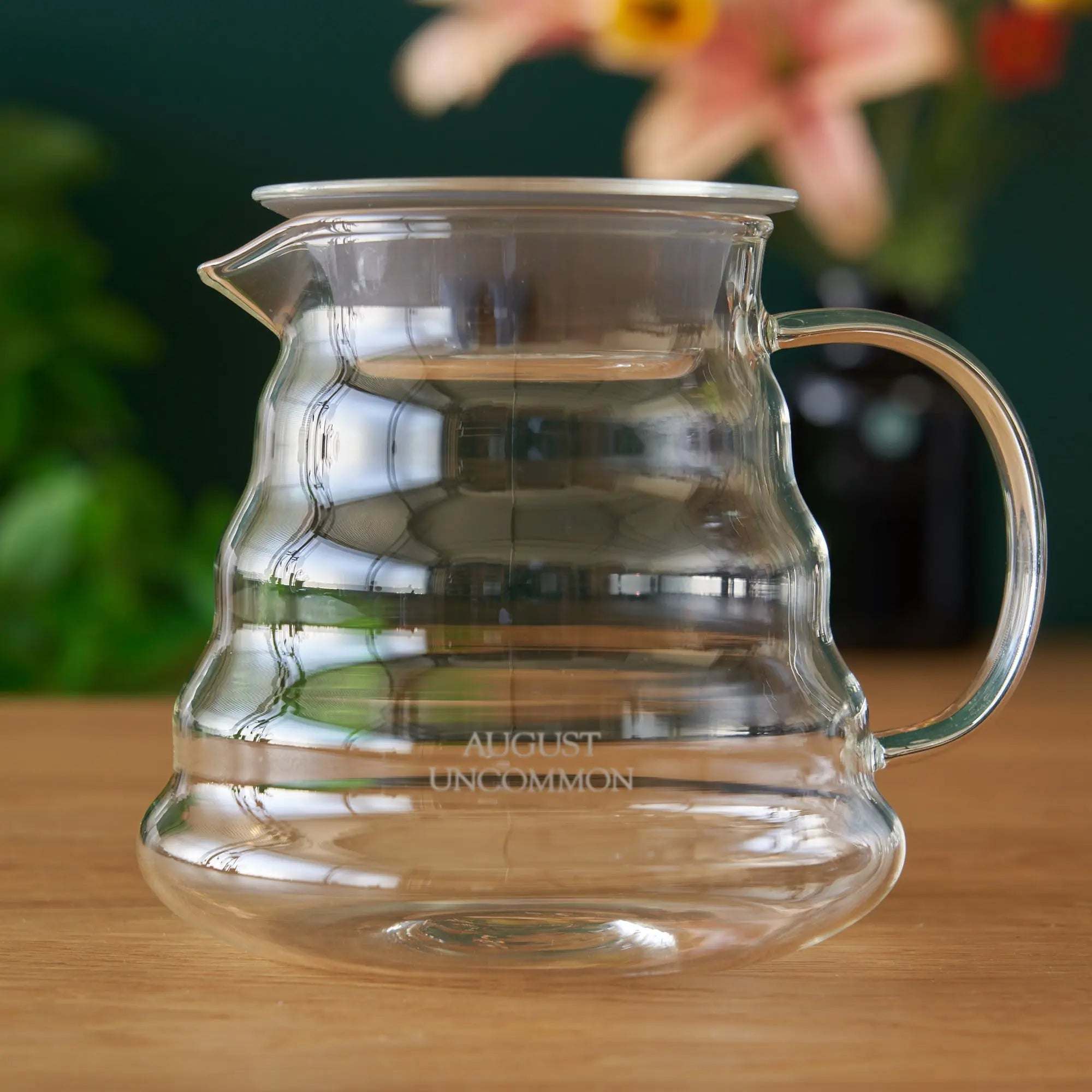 Two Cup Glass Teapot in clear heatproof glass with a curved handle, spout, lid, and flared base