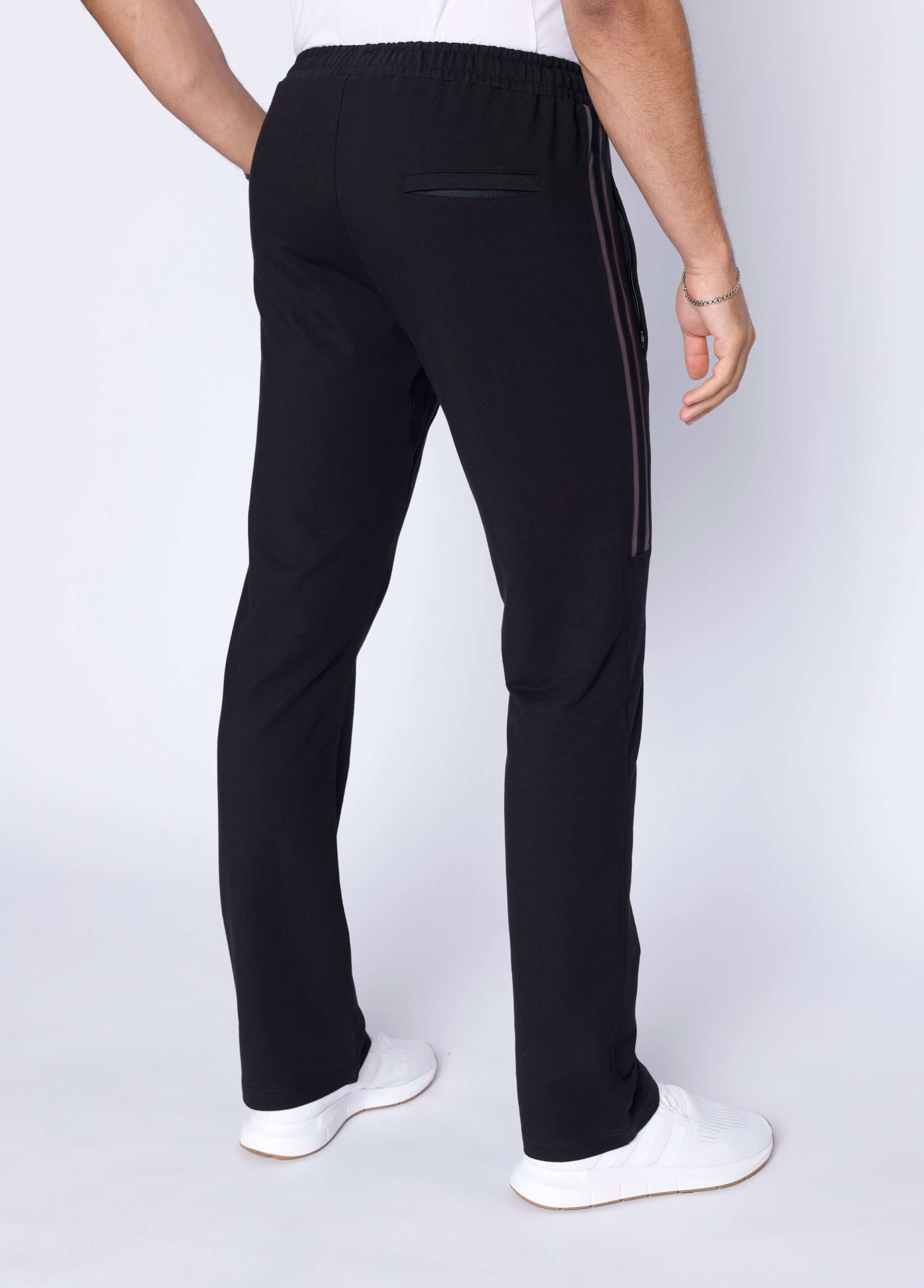 Ultimate Flex Athletic Sweatpants in black stretch fabric, shown from the rear with straight legs and a zippered pocket