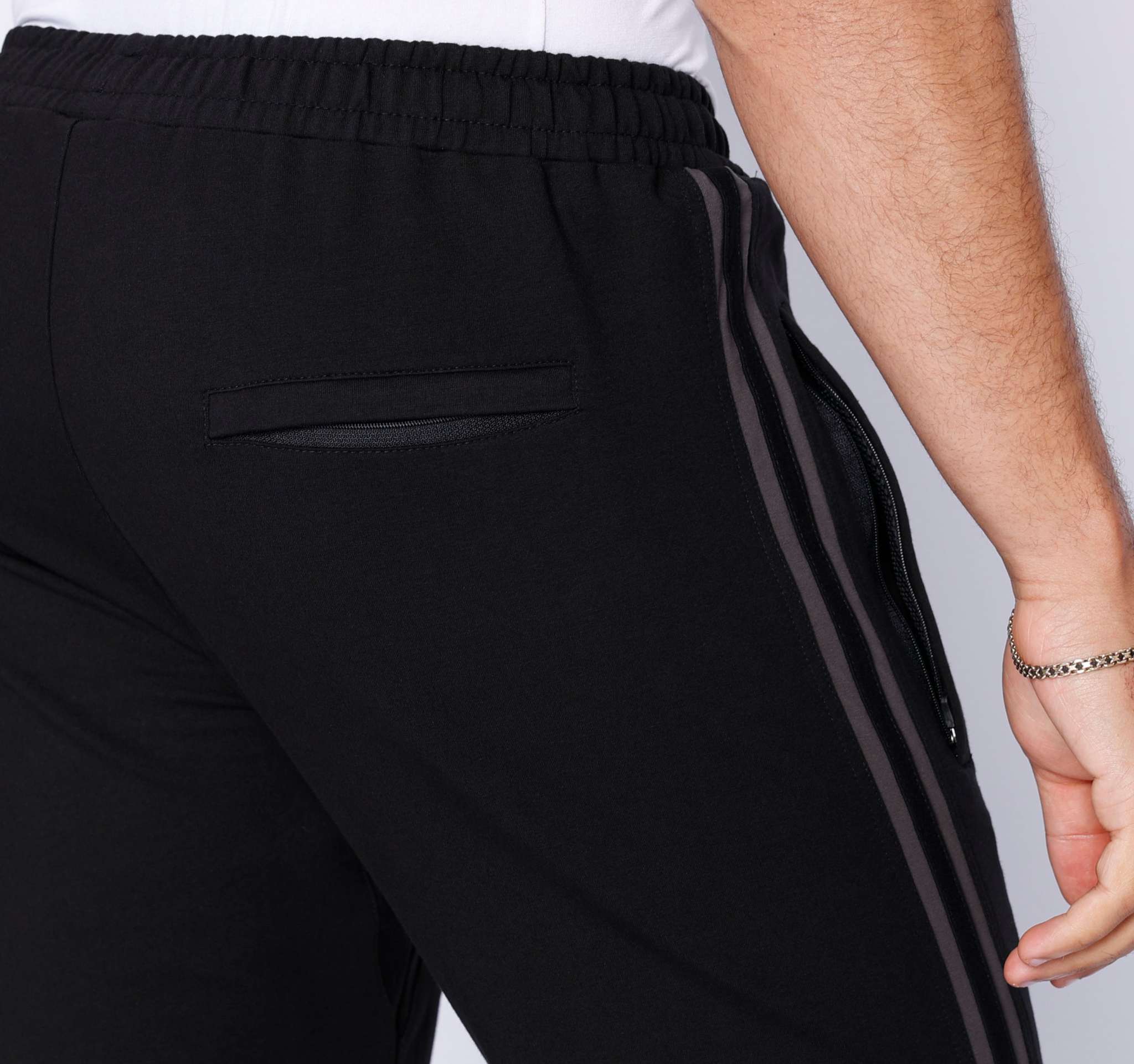 Ultimate Flex Athletic Sweatpants in black stretch fabric with an elastic waistband, straight leg, and zippered side pocket