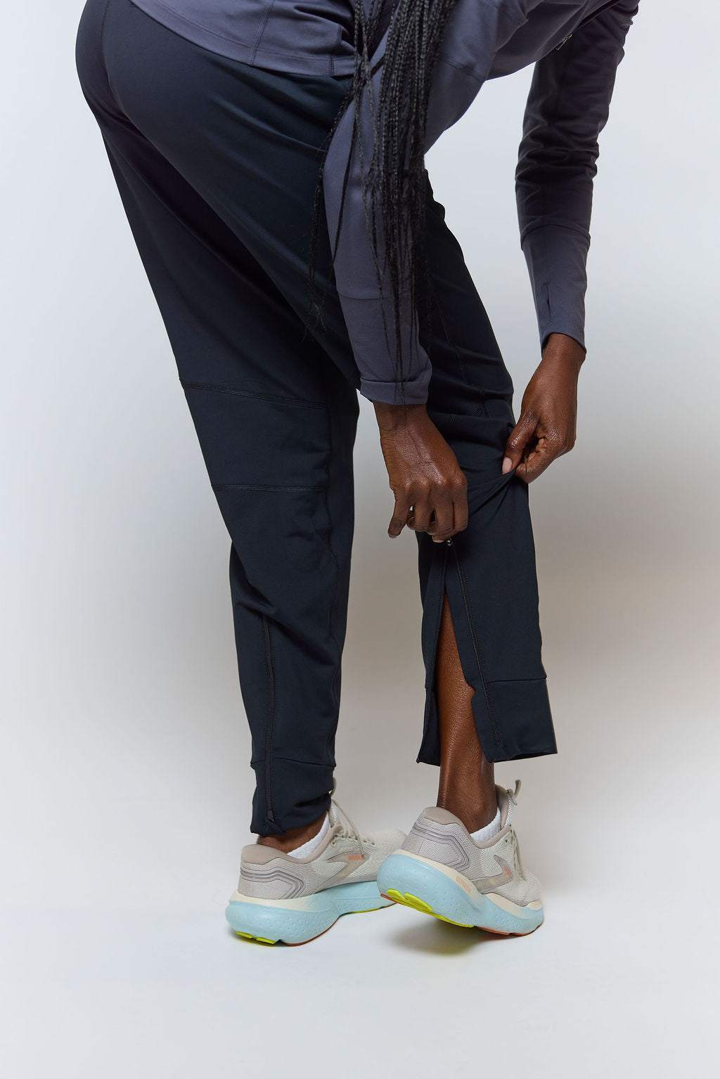 Valia Women's Black Jogger Pants in smooth black fabric with a slim athletic fit and ankle zippers