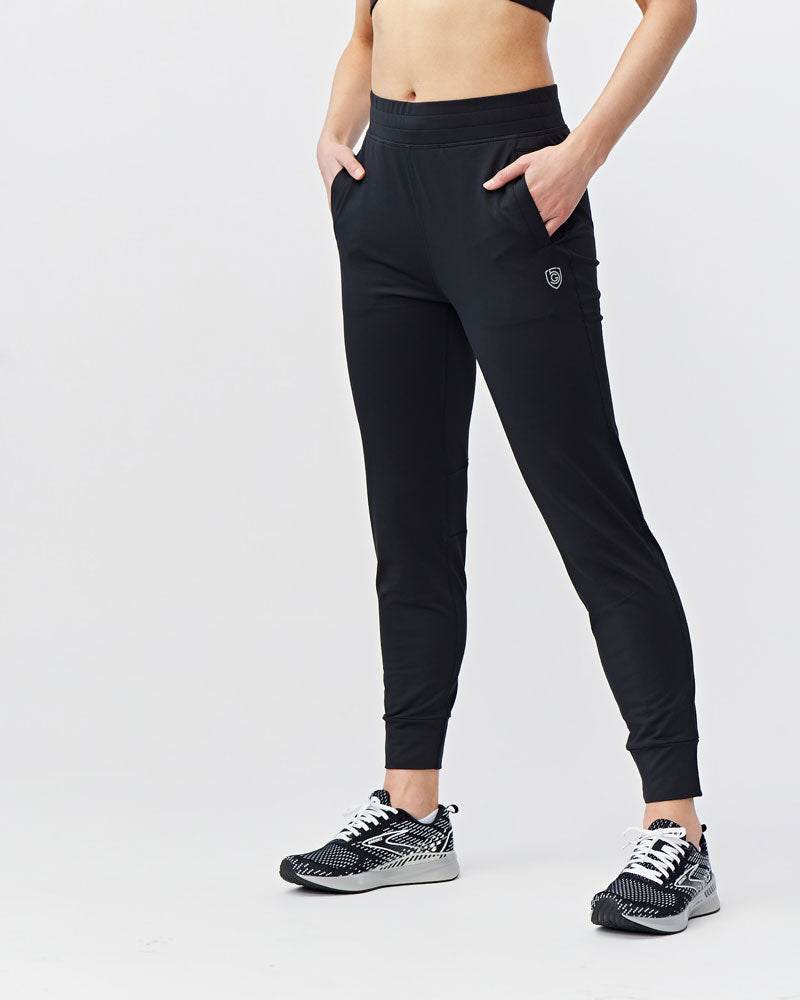 Valia Women's Black Jogger Pants in black stretch fabric, with a slim athletic fit, tapered legs, ankle cuffs and side pockets