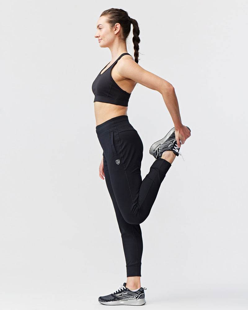 Valia Women's Black Jogger Pants in black athletic fabric with a slim fit, tapered legs, and a small logo