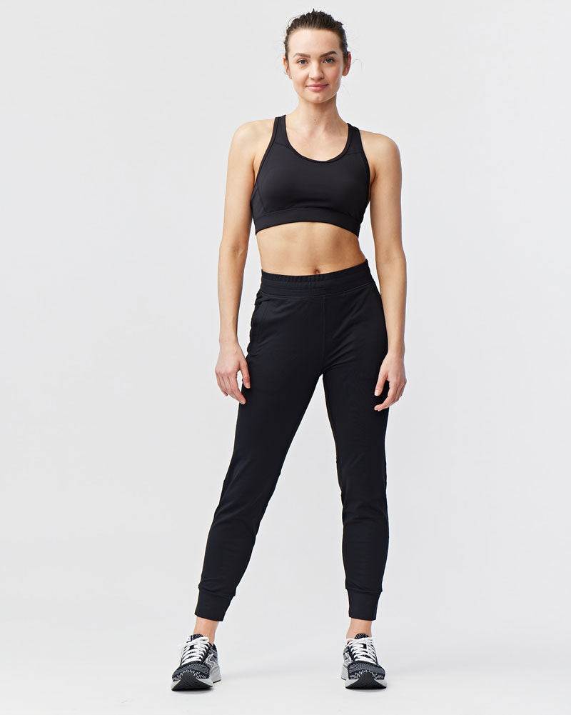 Valia Women's Black Jogger Pants in solid black with a smooth finish, elastic waistband, tapered legs and ankle cuffs