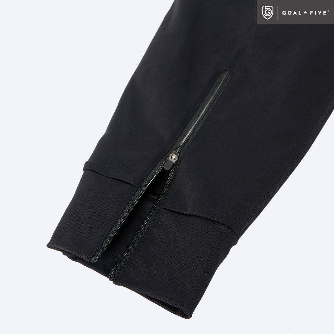 Valia Women's Black Jogger Pants in black fabric with a long ankle zipper and smooth paneled cuff.