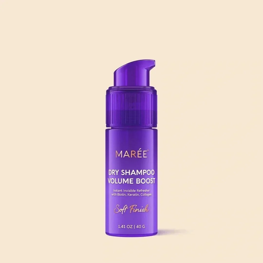 Volumizing Dry Shampoo Powder in a vivid purple cylindrical pump bottle with a clear cap and white and gold lettering