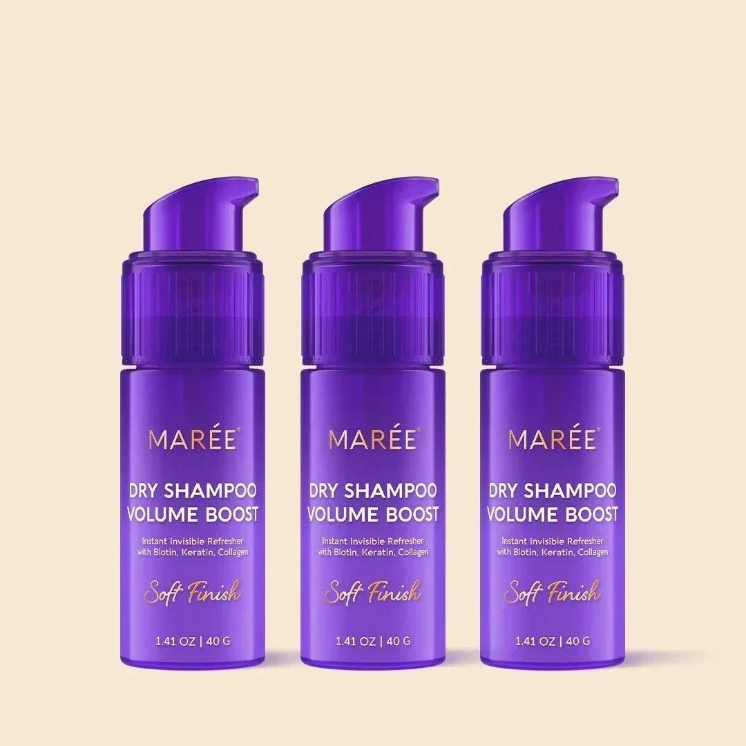 Volumizing Dry Shampoo Powder in three purple aerosol-free pump bottles with gold lettering and a compact design