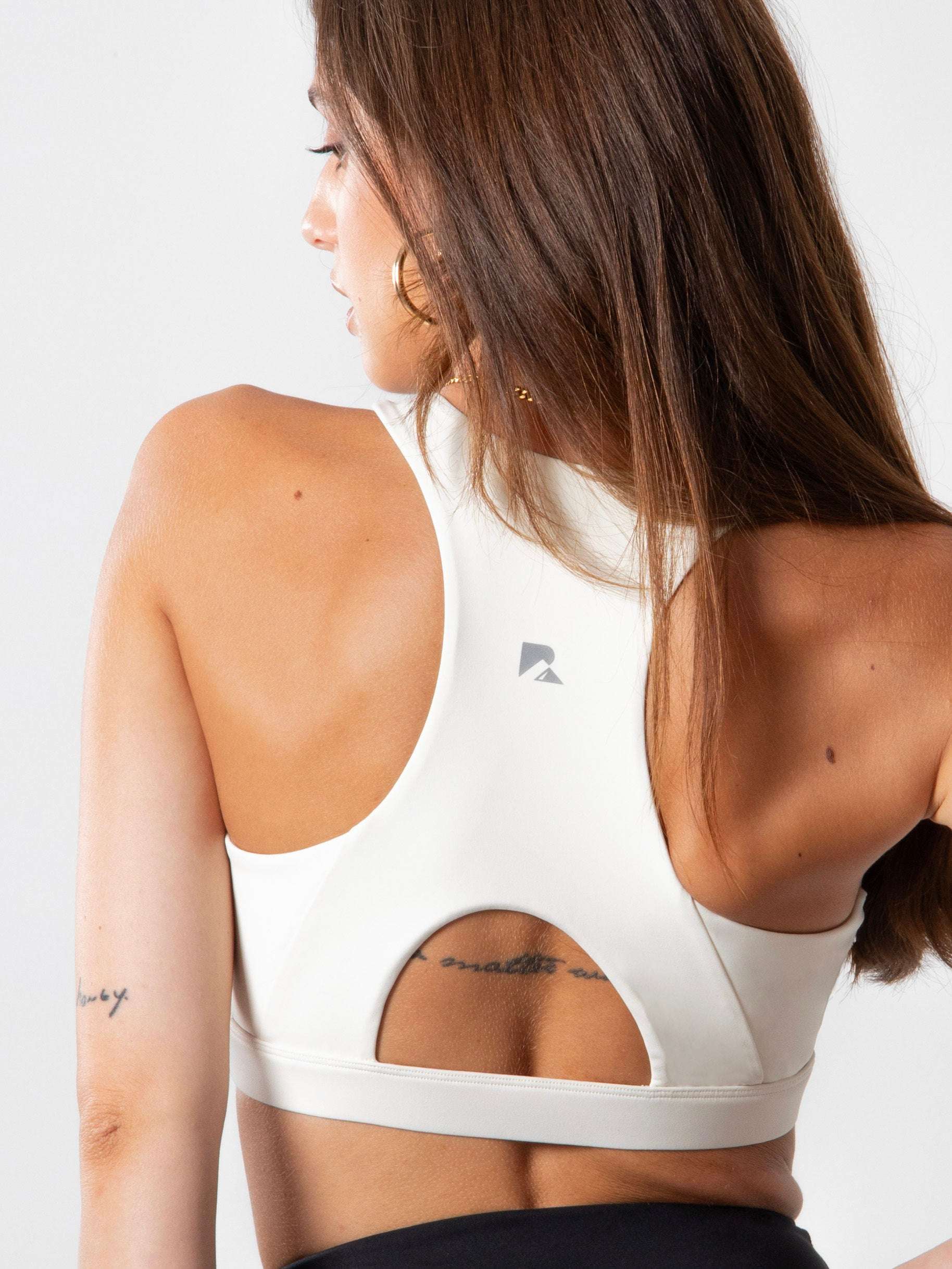 Women's Heart Neckline Sports Bra in white stretch fabric, featuring a racerback cutout and wide supportive band