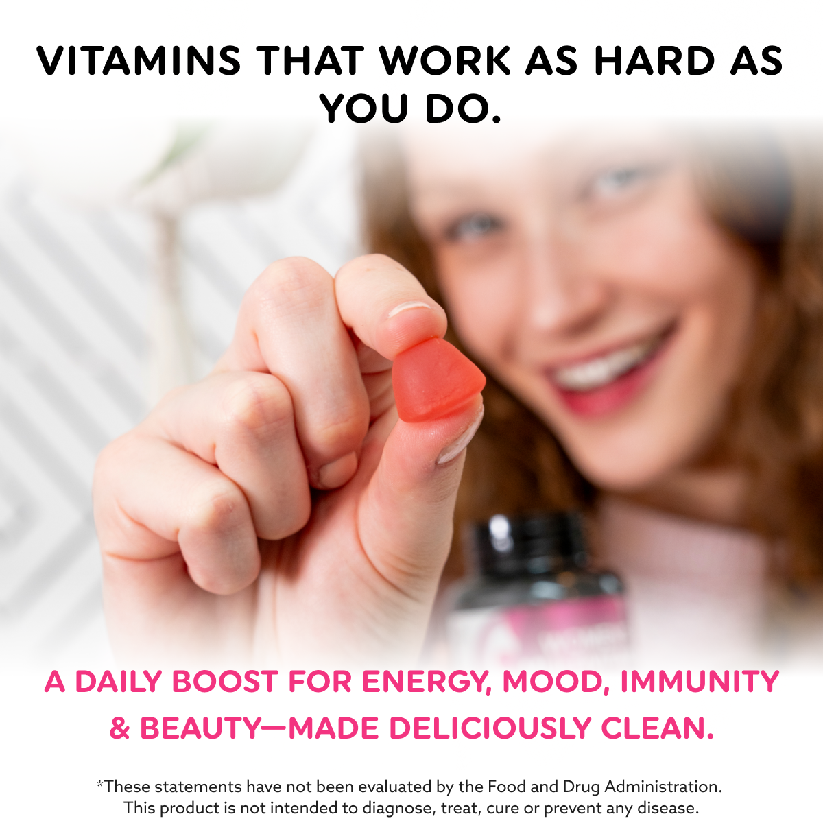 Women's Multivitamin Gummies with a red, heart-shaped gummy held between fingers, with a vitamin bottle nearby