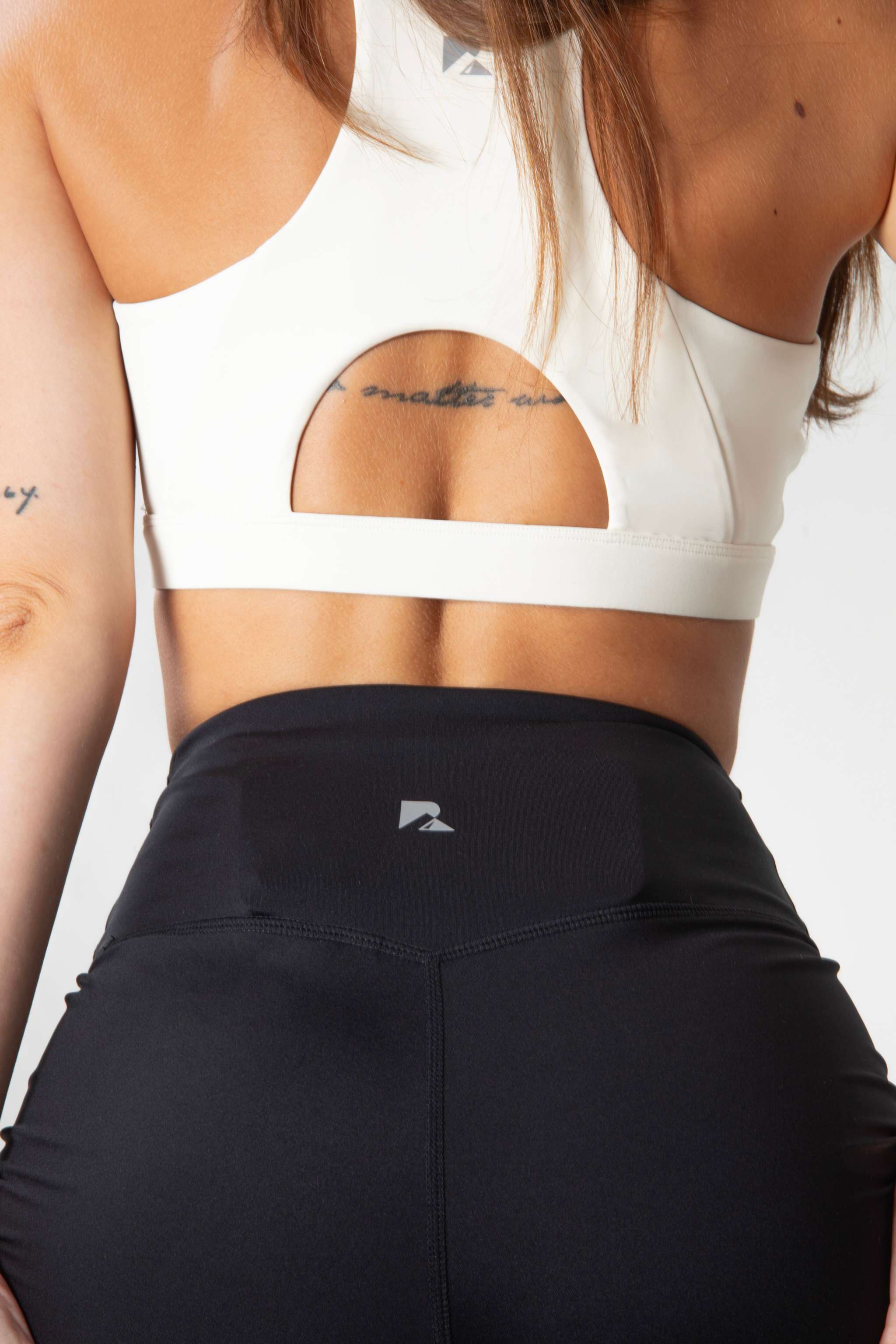 Women's Sculpting Workout Shorts in black stretch fabric with a high criss-cross waistband and small logo