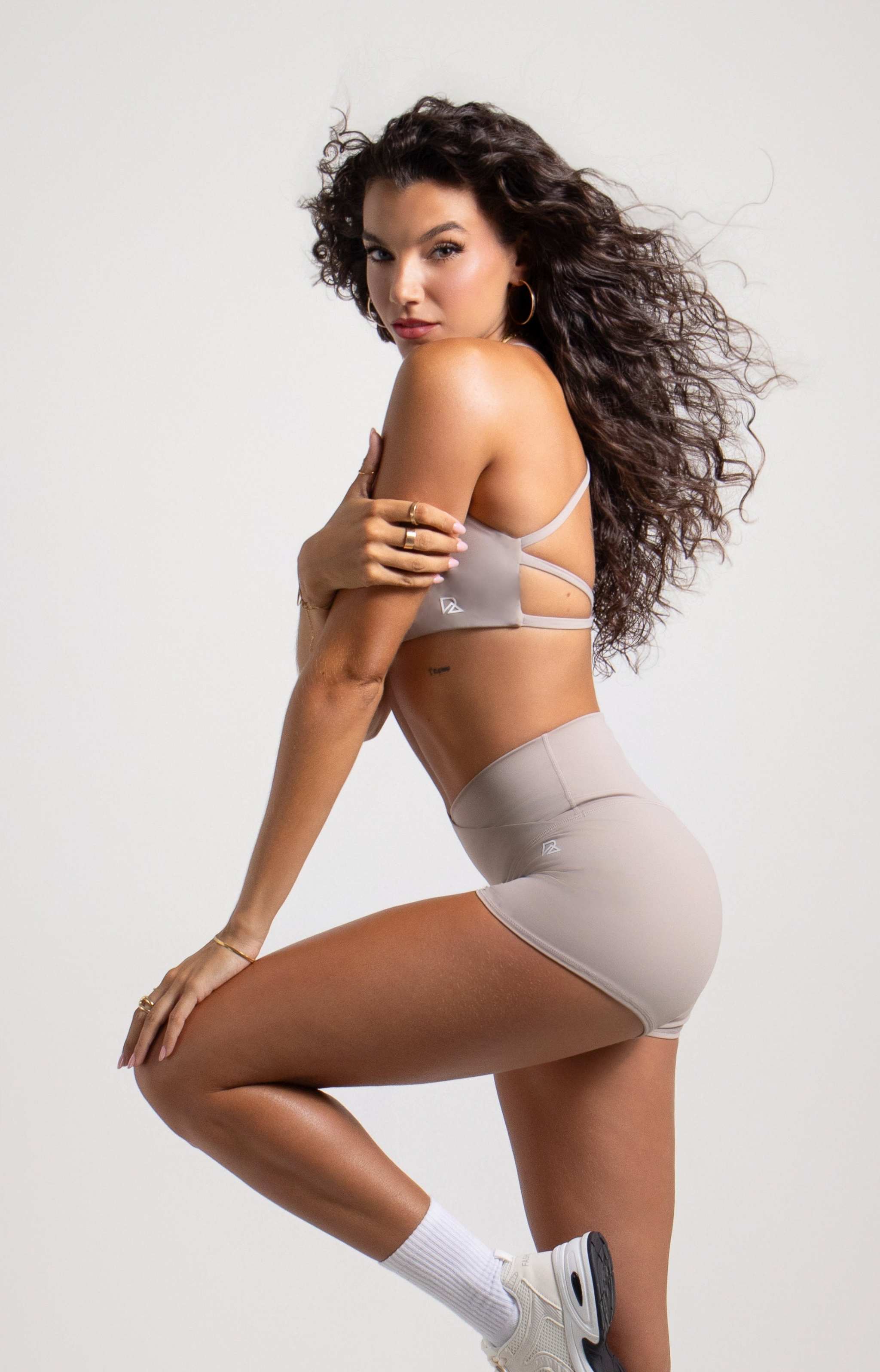 Women's Strappy Open-Back Sports Bra in taupe, a smooth stretch fabric with thin crisscross back straps and scoop neckline
