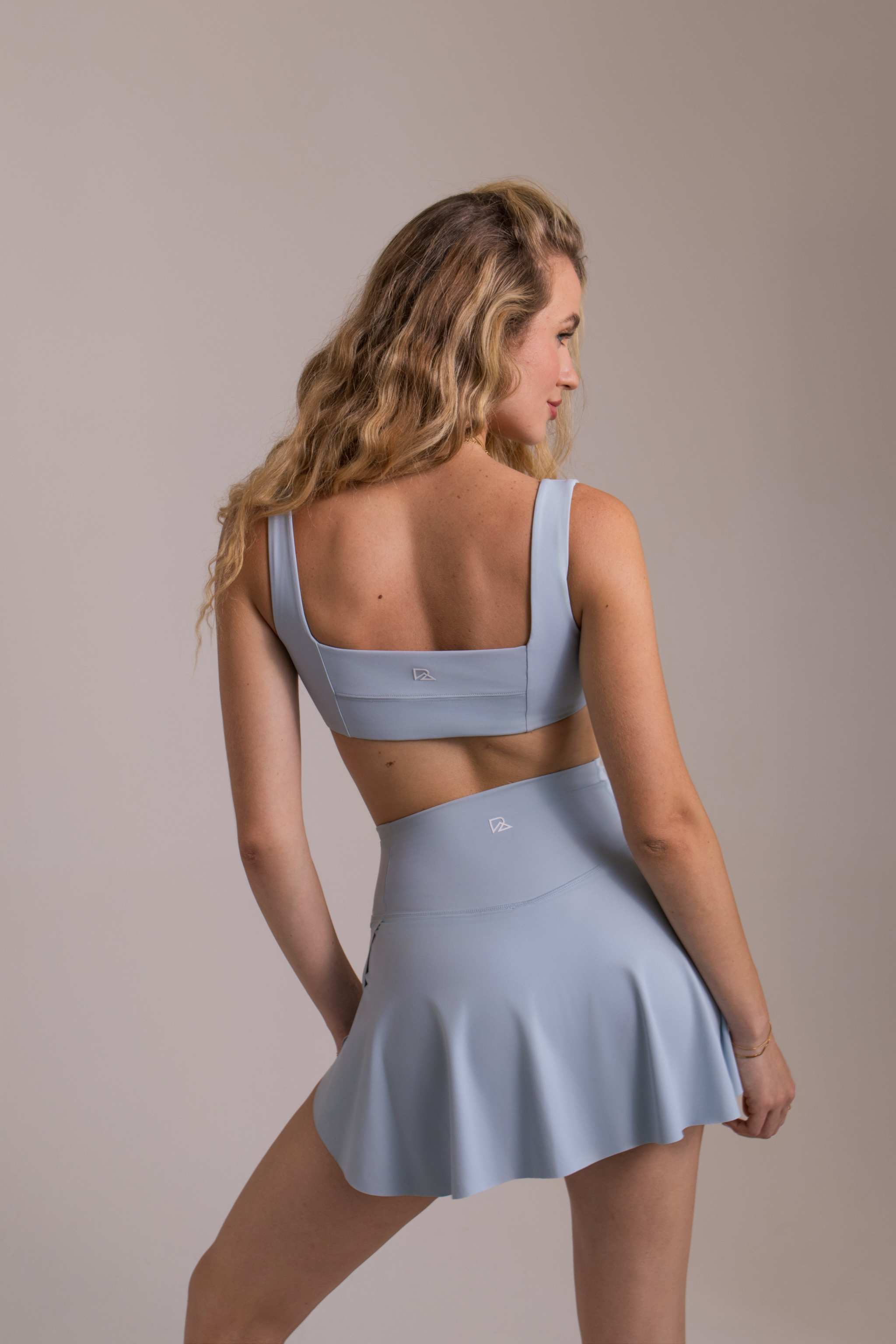 Women's Athletic Skort in pale blue stretch fabric with a flared skirt and matching square-back crop top