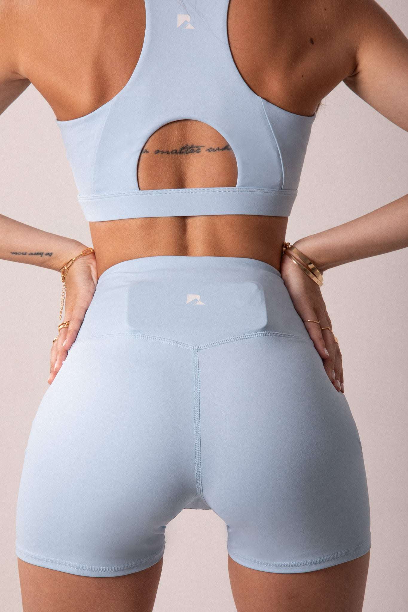 Women's Sculpting Workout Shorts in pale baby blue, smooth stretch fabric with a high criss-cross waistband and fitted 5-inch legs