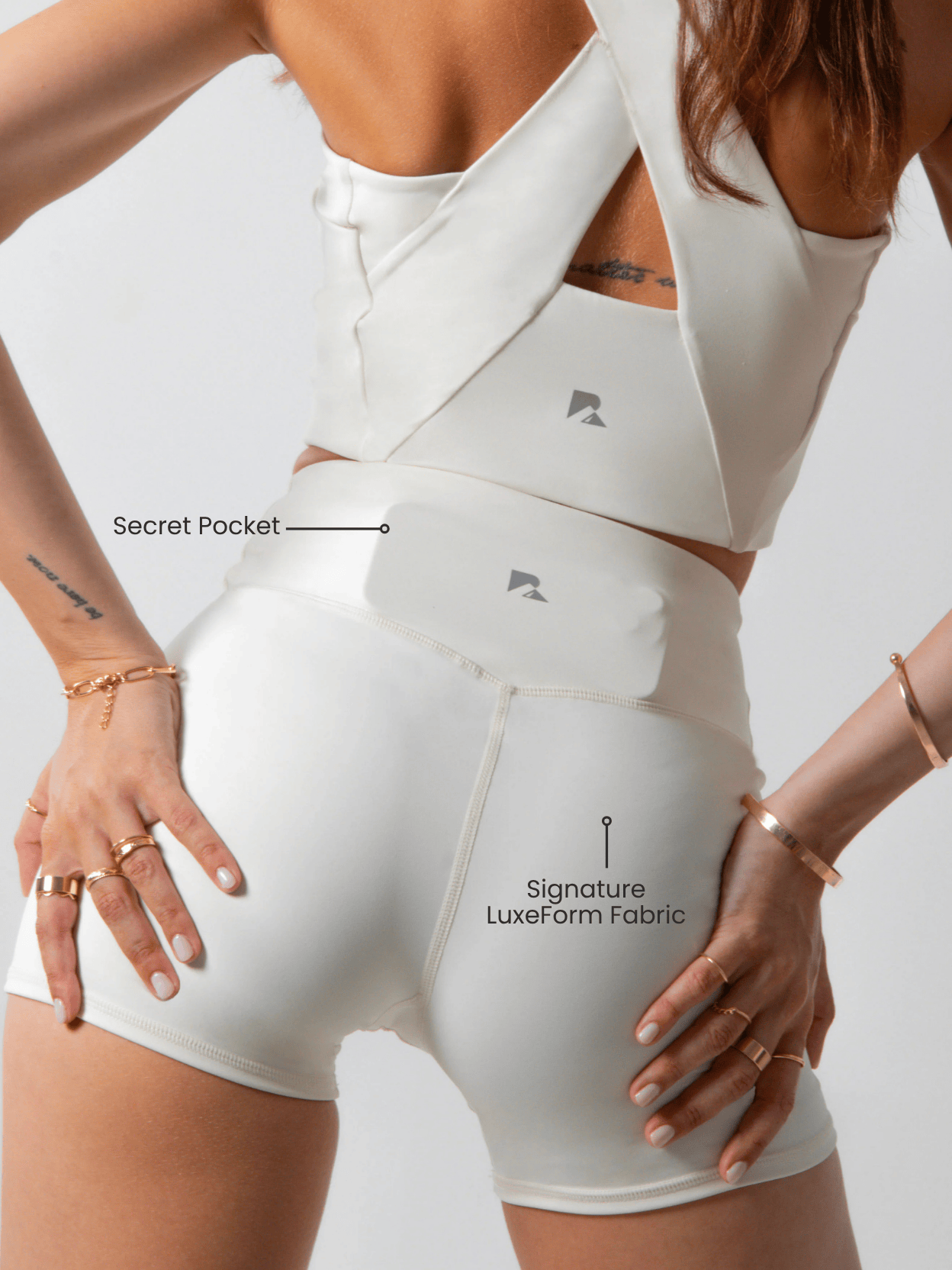 Beige women's sculpting workout shorts with criss-cross waistband and pocket