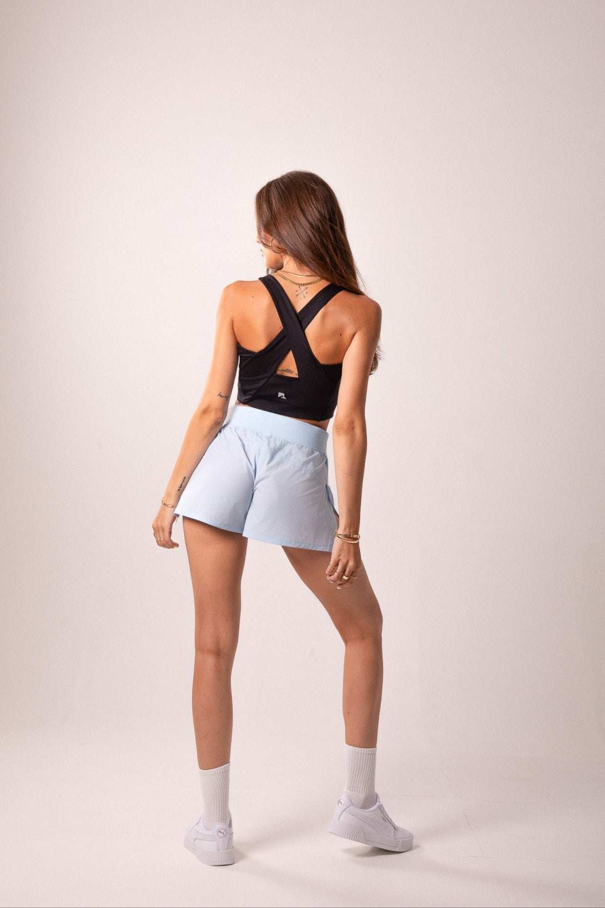 Women's Workout Tank Top in black stretch fabric with a criss-cross back and triangular cutout details